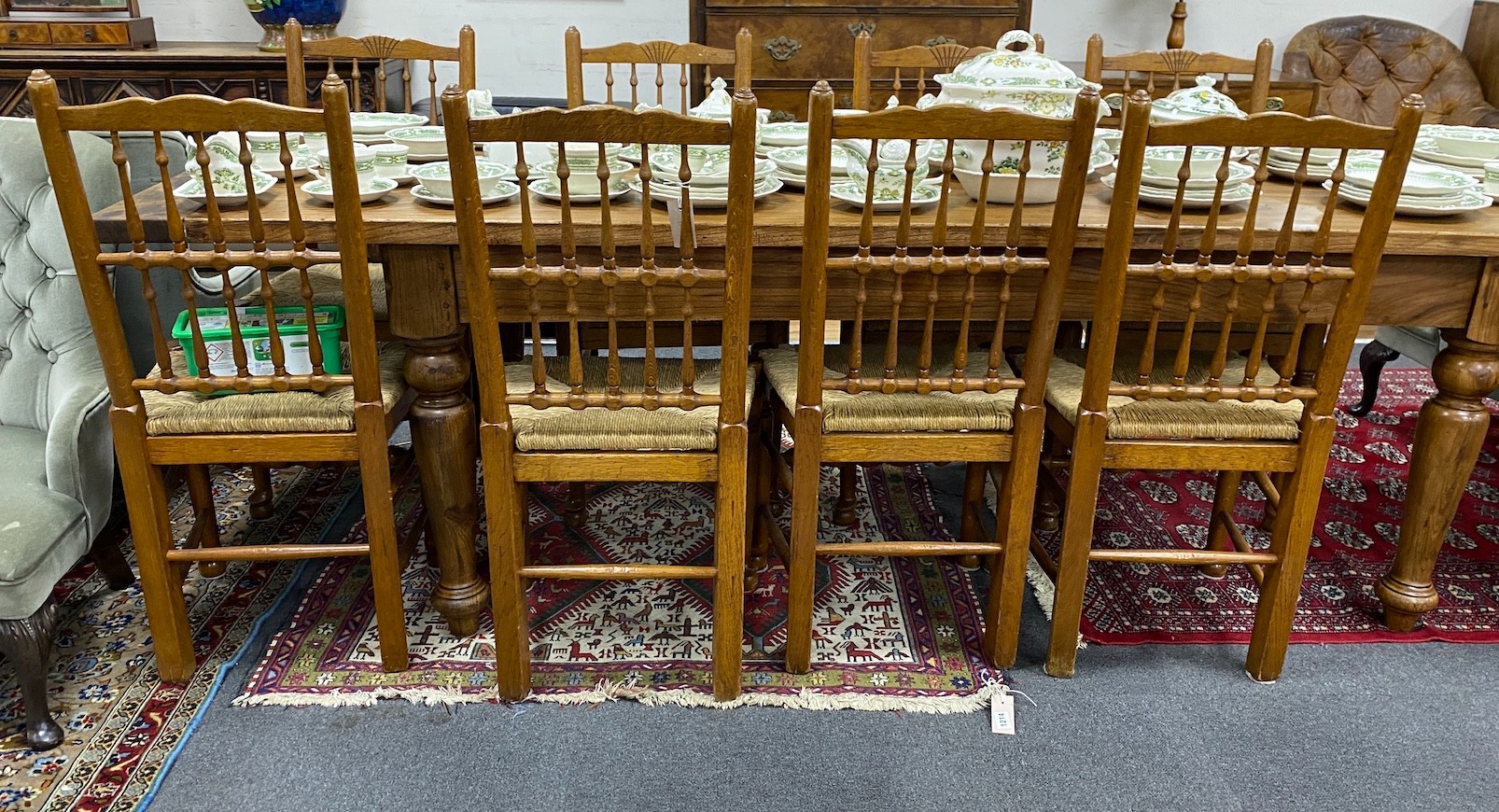 A set of eight Lancashire style oak spindle back rush seat dining chairs